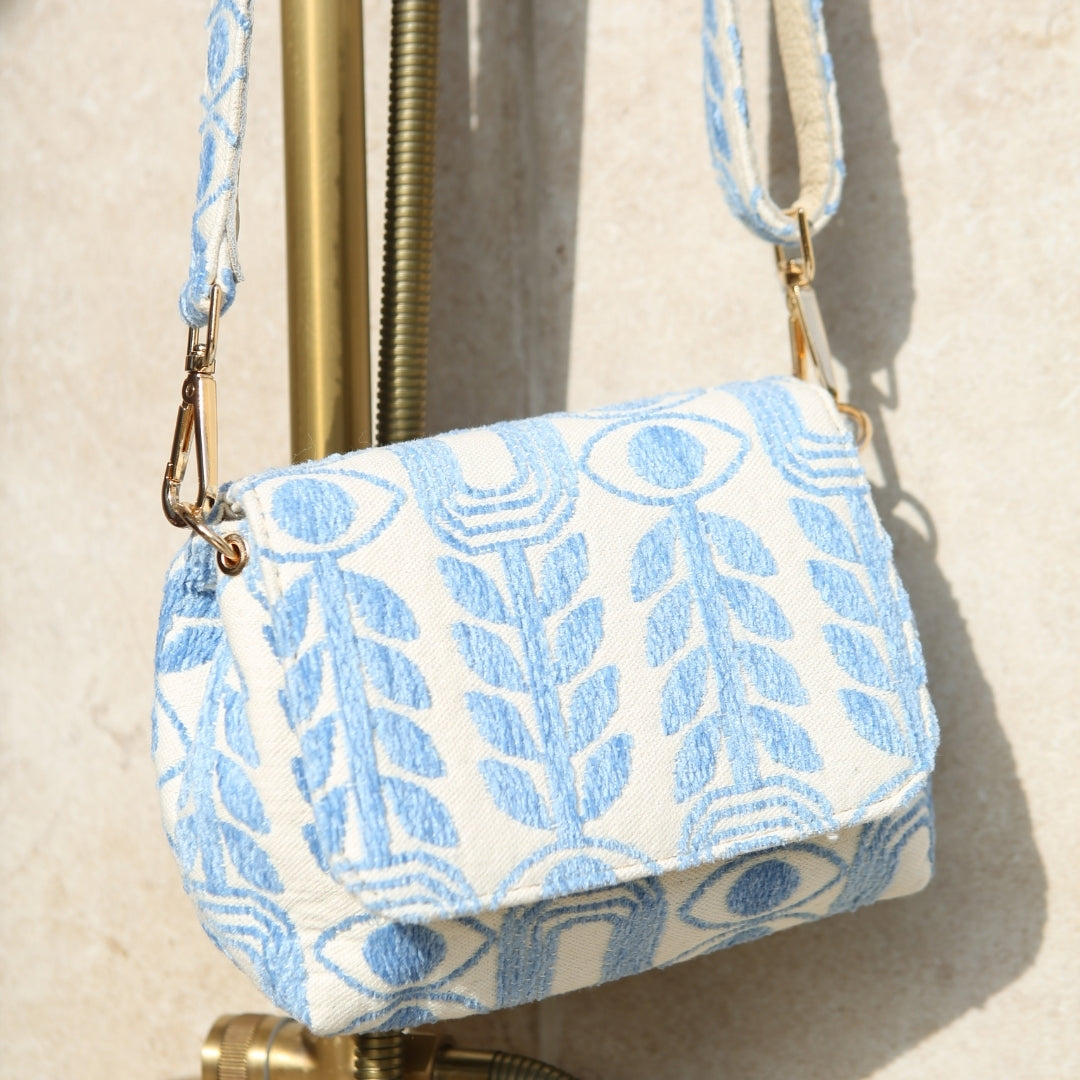Marabu crossbody bag detail — light blue Unity print cotton with gold clasp and adjustable printed strap, made in Greece