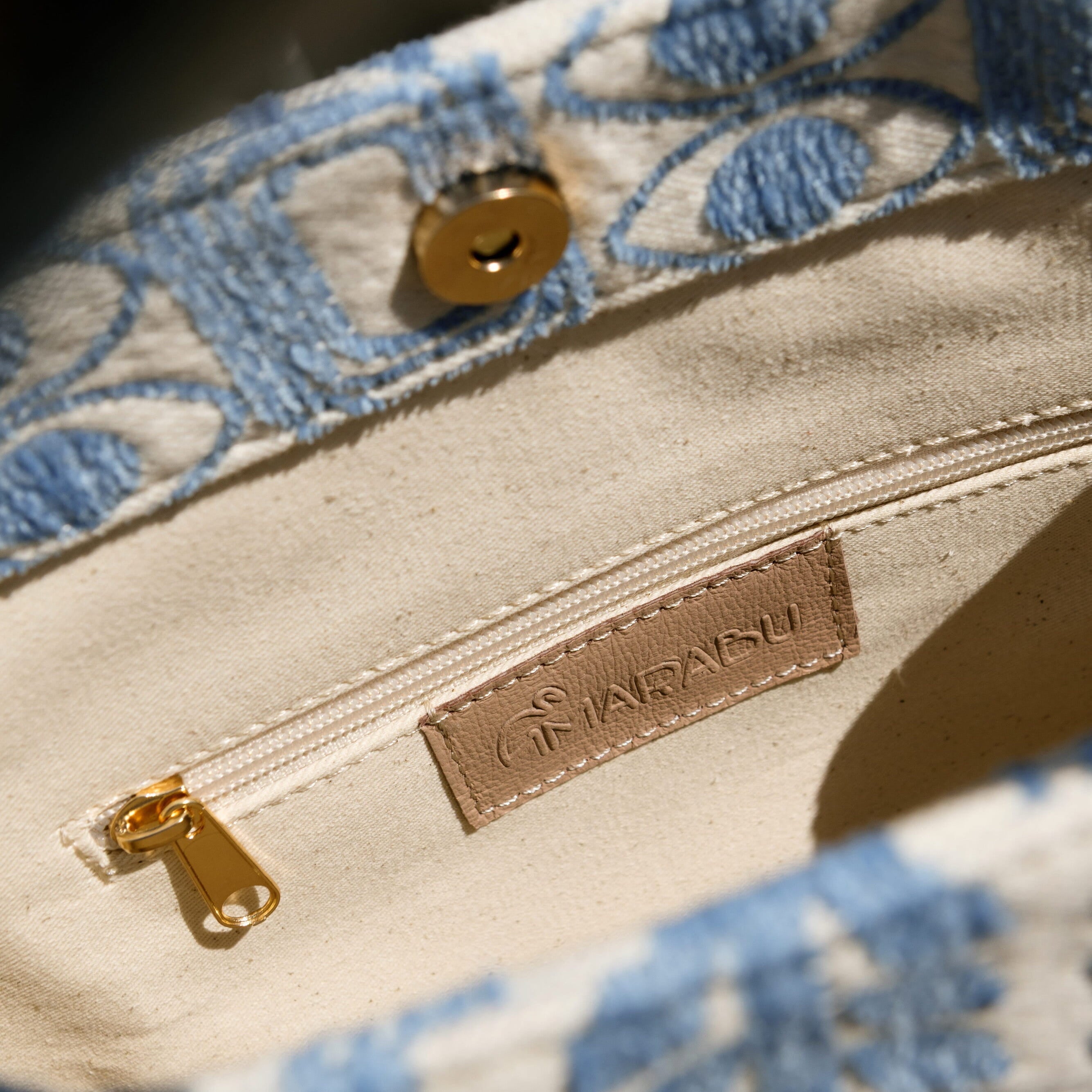 Marabu Unity Square Tote Bag interior — natural cotton lining with gold hardware and embossed Marabu leather label, handmade in Greece