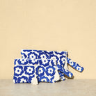 Marabu flower clutch in deep blue — bold floral print on natural cotton, tassel zip, three sizes, handmade in Greece