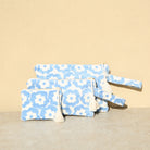Marabu flower clutch in light blue — cheerful floral print on natural cotton canvas, three sizes, made in Greece