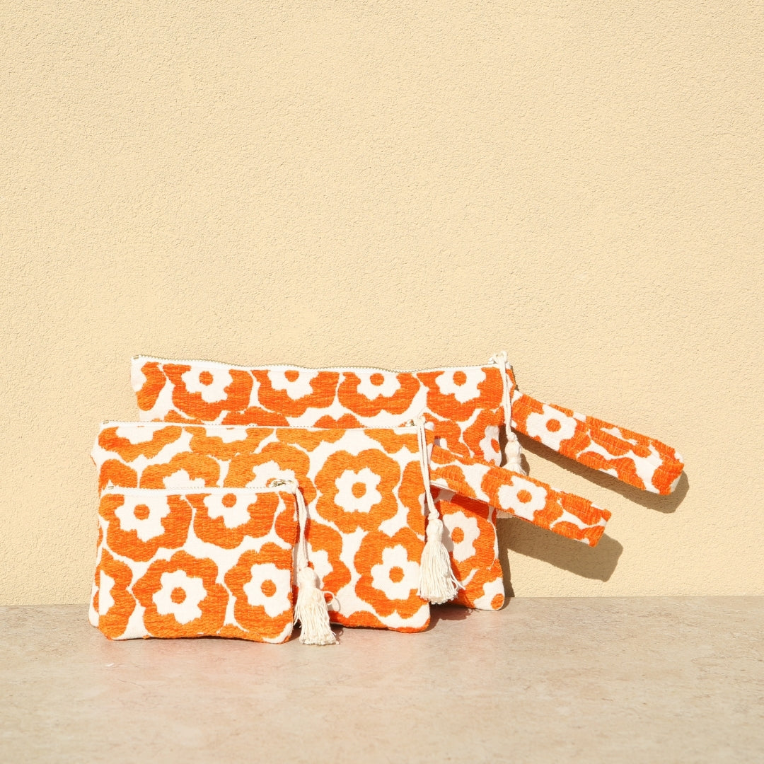 Marabu flower clutch in orange — bold floral print on natural cotton canvas, tassel zip, handmade in Greece
