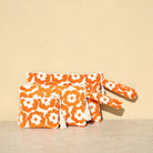 Marabu flower clutch in orange — bold floral print on natural cotton canvas, tassel zip, handmade in Greece