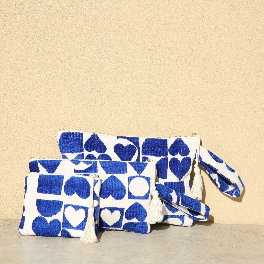 Marabu heart clutch in deep blue — bold heart and geometric print on natural cotton, tassel zip, three sizes, handmade in Greece