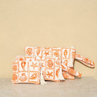 Marabu seashell clutch in orange — bold coastal print with shells and starfish, natural cotton, handmade in Greece