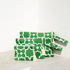 Marabu star clutch in green — bold geometric star print on natural cotton, tassel zip, three sizes, handmade in Greece
